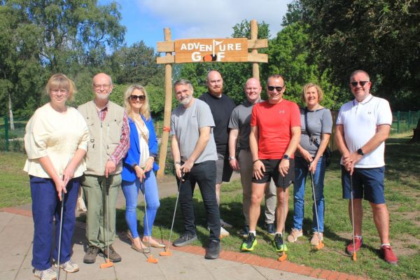 A picture of Councillors Andy Smith (third from right) and Darren Ennis (fourth from left) opening the new Adventure Golf with Lichfield District Council staff and Friends of Beacon Park on Saturday.