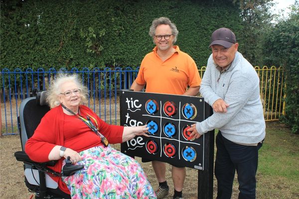 A picture of Councillor Kathy Coe, Community Gardener Paul Niven and Councillor Phil Whitehouse, Cabinet Member for Operational Services, Parks and Waste with one of the interactive play panels are.
