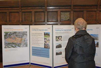 image of woman looking at Birmingham Road Site information board