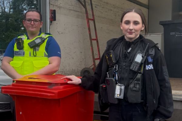 A picture of PCSO Deryn Small (left) and PC Bethany Hill with the bin containing collected blades.
