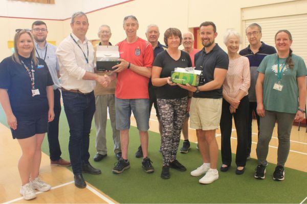 A picture of Indoor bowlers at Curborough Community Centre receiving new bowls from Ashley Worsfold, Projects Director at Ascot Services (left) and Jared Freeman, Social Value Lead at Lichfield District Council.