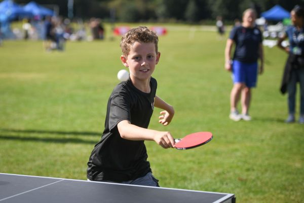 A picture of a boy playing table tennis.