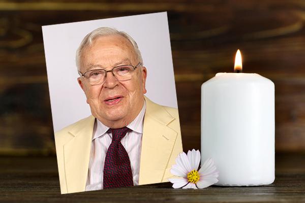 image of Doug Constable next to flower and candle