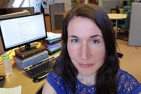 image of Esther sat at her desk