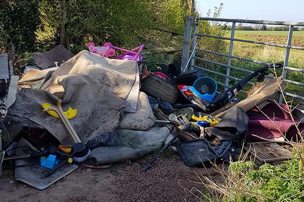 Image of fly-tipping by gate
