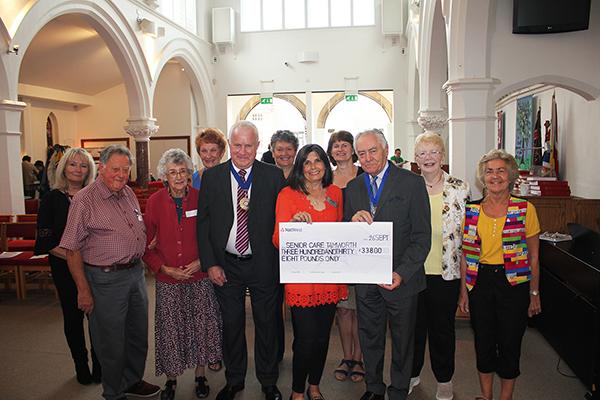 group of people with former chairman and Karen holding giant cheque