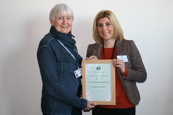 Picture of two women holding an award