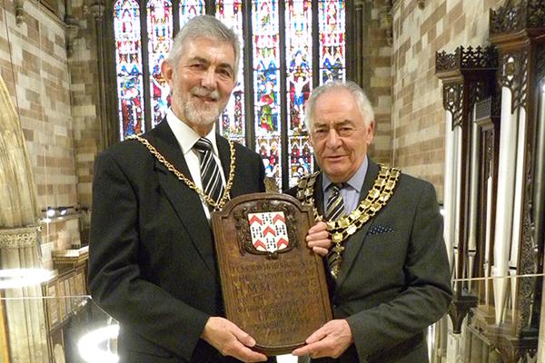 David Leytham and Bob Awty holding plaque in St Mary's