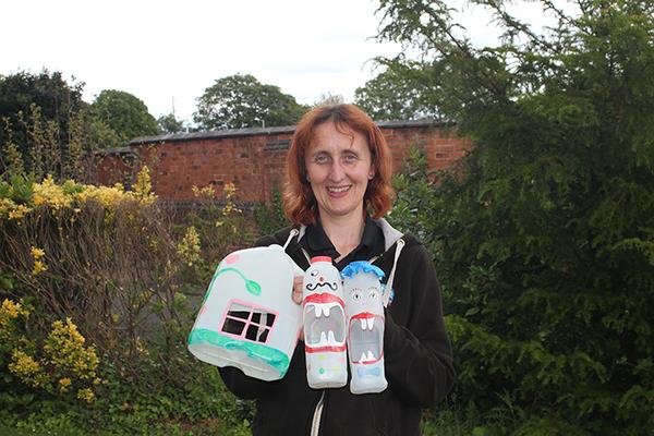 Woman holding decorated milk bottles