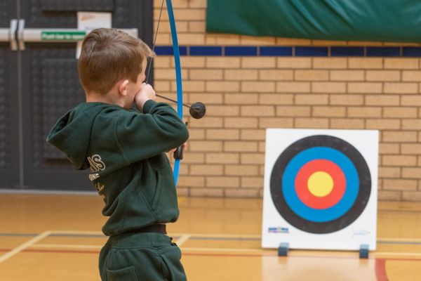 A picture of a young person playing soft archery.
