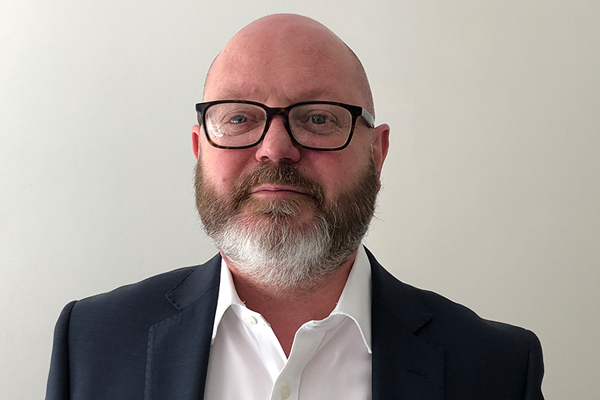 man in suit wearing glasses with beard