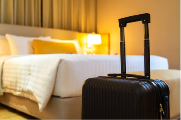 a hotel room with a suitcase in it