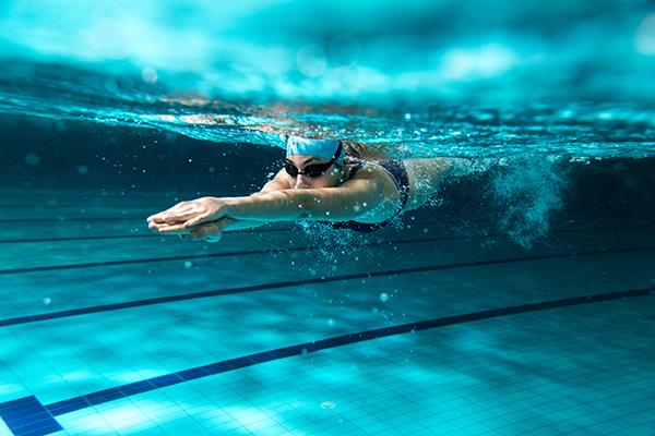 woman swimming in a pool underwater