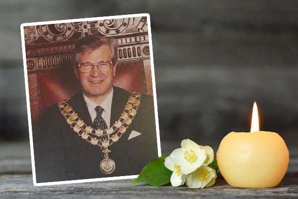 Portrait of Tony Nichols next to flower and candle