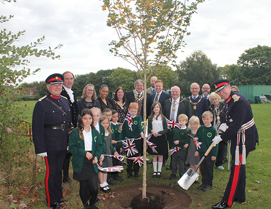 dignitaries and pupils with tree