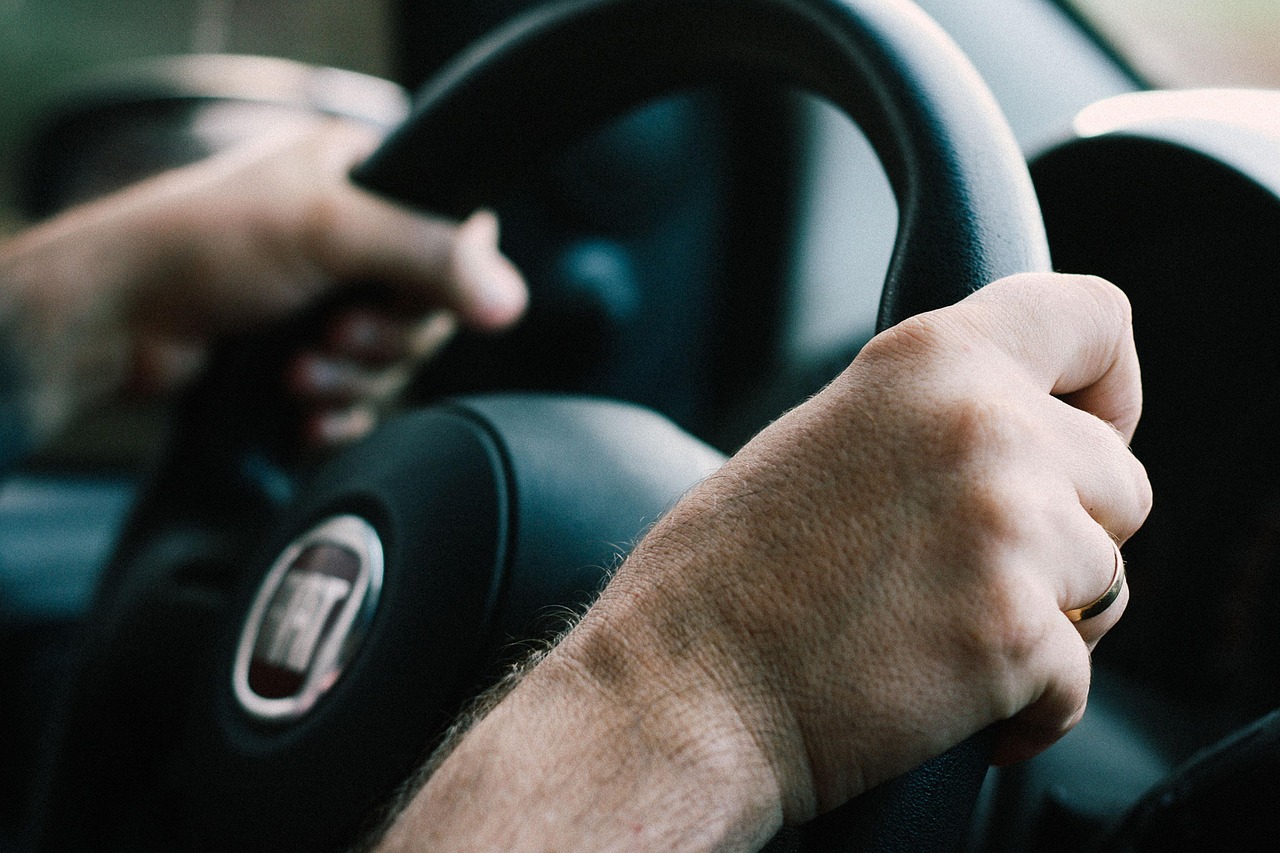 Hands holding a steering wheel
