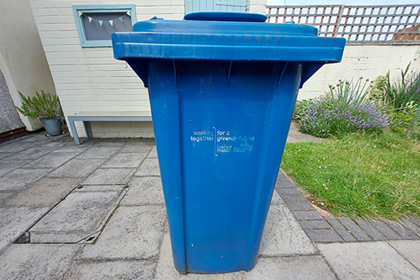 blue wheelie bin in garden