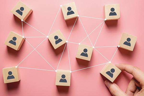 wooden blocks representing people connected in a hive structure