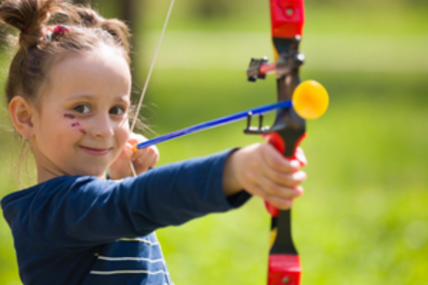 young girl playing soft archery