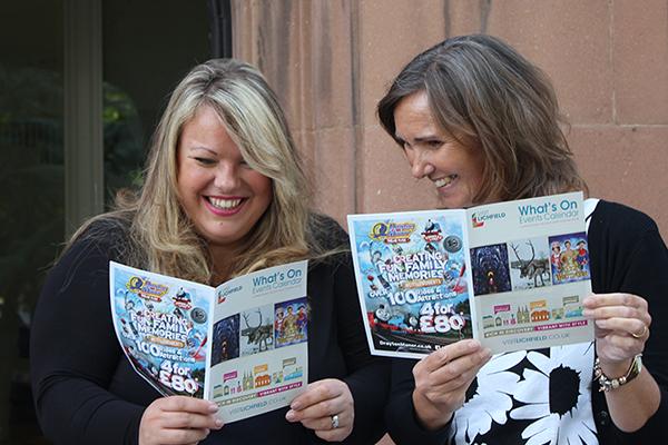 two women looking at What's On brochure