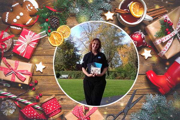 festive scene with picture of woman holding handmade Christmas cards
